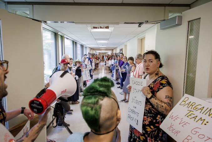 USA members and their allies line the hallway outside the UMass Chancellor's Office. Photo by Douglas Hook / The Republican.